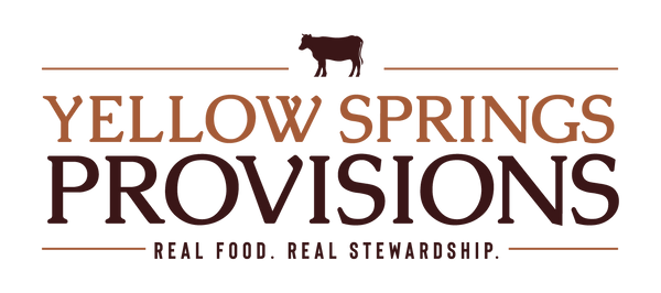 Yellow Springs Provisions logo on a white background, featuring a brown cow silhouette above the words 'YELLOW SPRINGS PROVISIONS' in brown and dark brown lettering, with the tagline 'REAL FOOD. REAL STEWARDSHIP'.